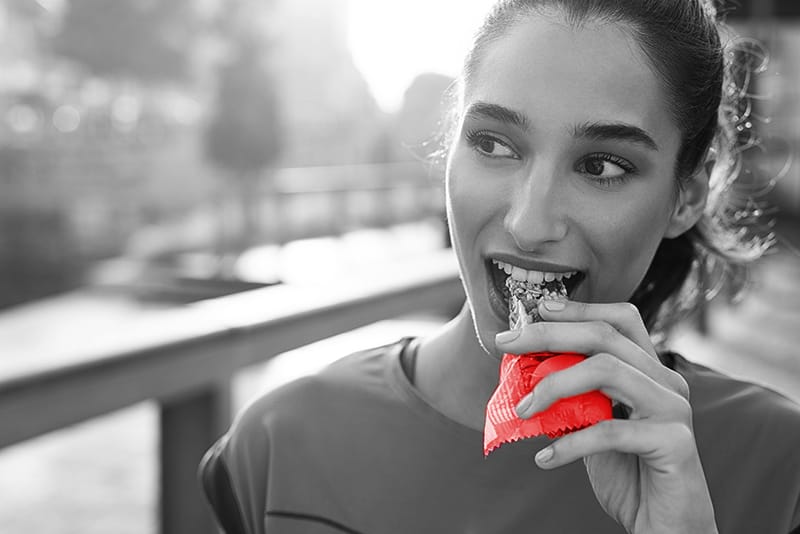 Women eating a protein bar