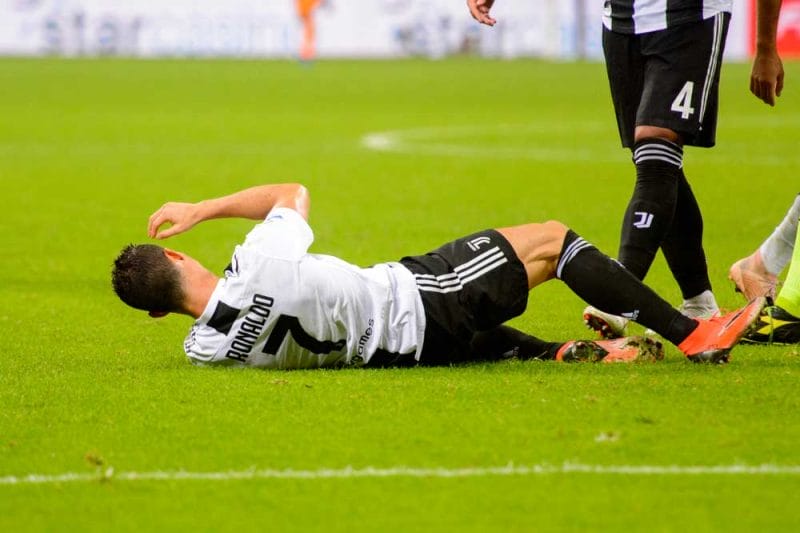 Cristiano Ronaldo 7 is injured on the grass. AC Milan - Juventus. Italian Serie A TIM. Giuseppe Meazza Stadium