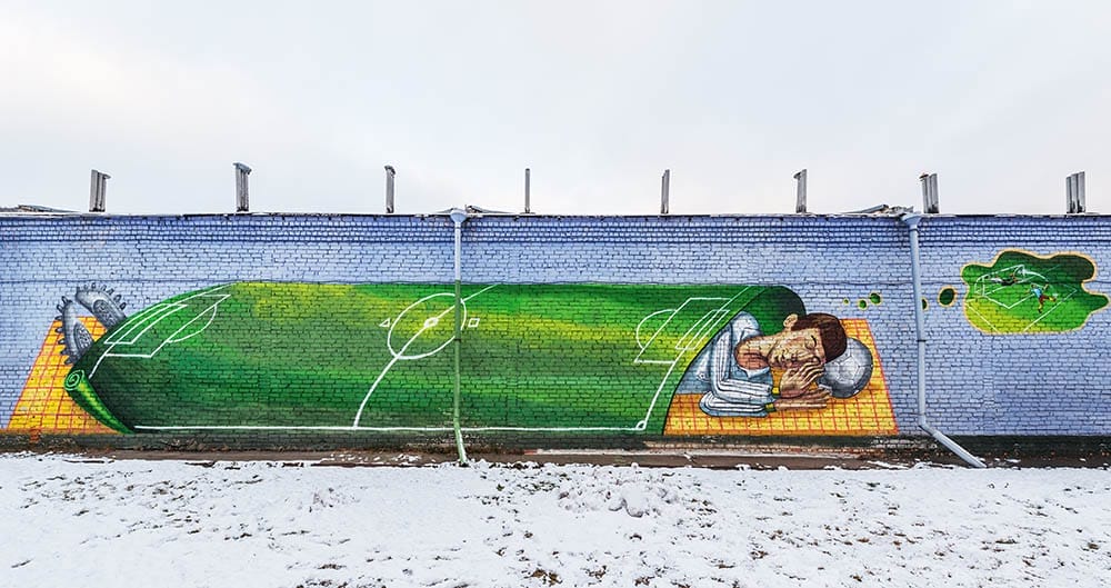 Korolev, Russia - November 27, 2015: Picture of the soccer player painted on the wall by the city stadium.