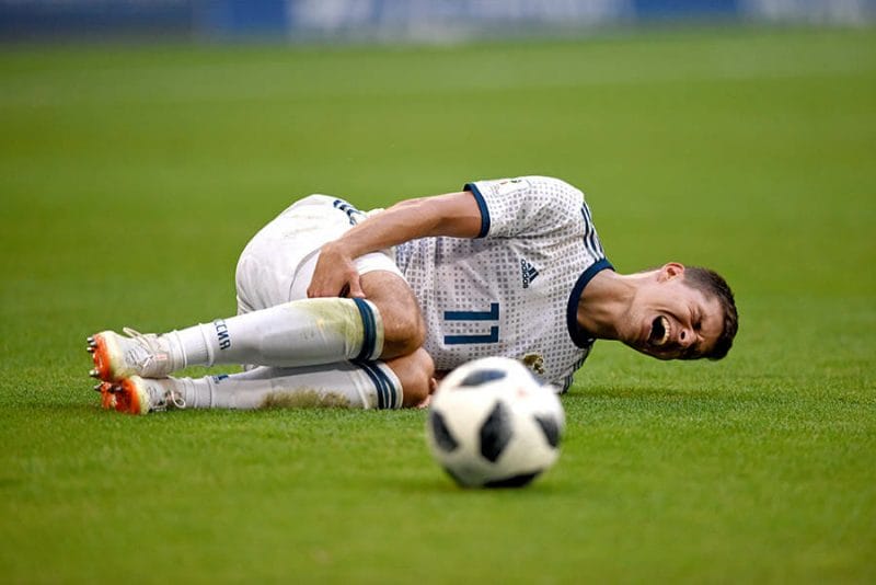 Samara, Russia - June 25, 2018. Russian midfielder Roman Zobnin lying on the pitch, after he was commited a foul upon, during FIFA World Cup 2018 match Uruguay vs Russia