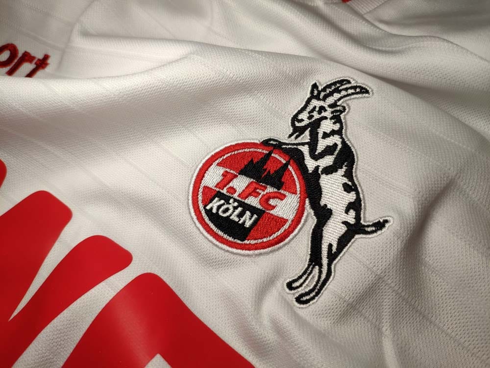 FC Köln emblem on the white jersey background