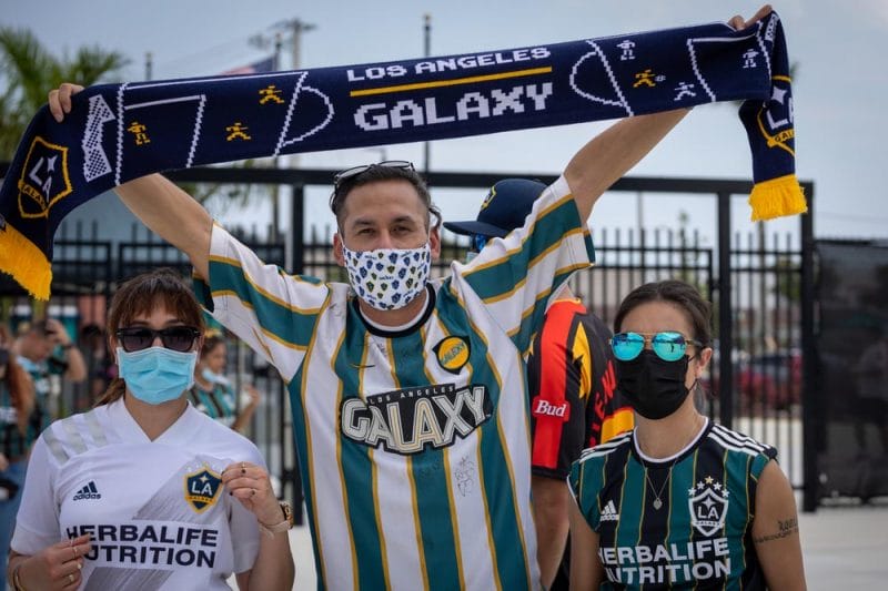 LA Galaxy soccer fans cheering on their team during a soccer match at MLS 2021 in DRV Pink Stadium.