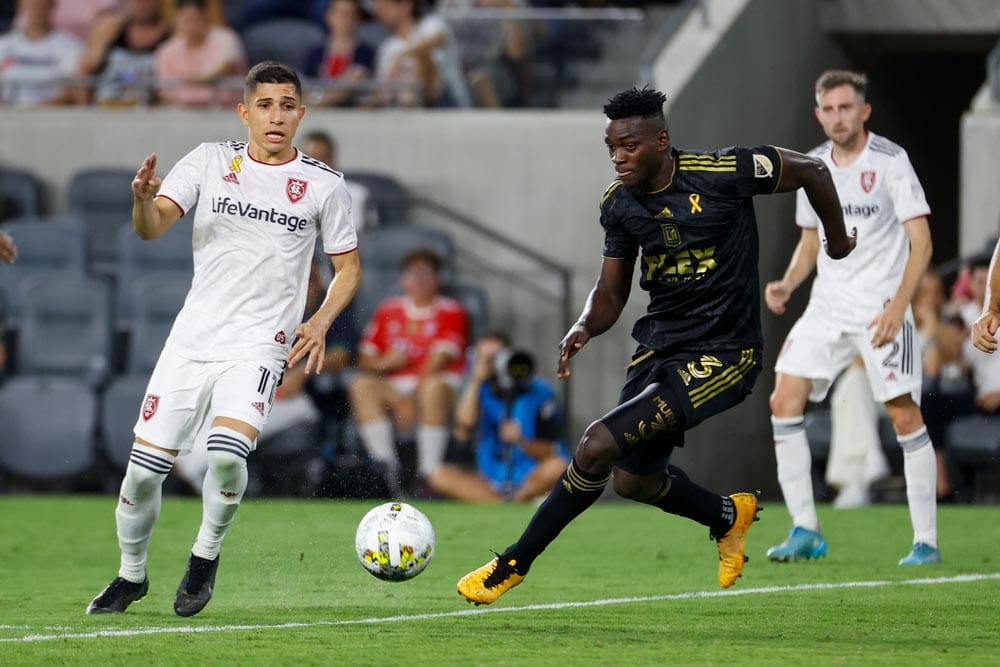 Los Angeles FC defender Jesus David Murillo (3) drives the ball away from Real Salt Lake forward Jefferson Savarino (11) during an MLS soccer match Sunday, Sept. 4, 2022, in Los Angeles.