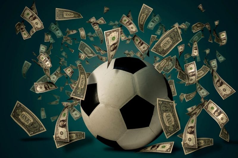 Soccer ball with dollar bills. Betting ideas