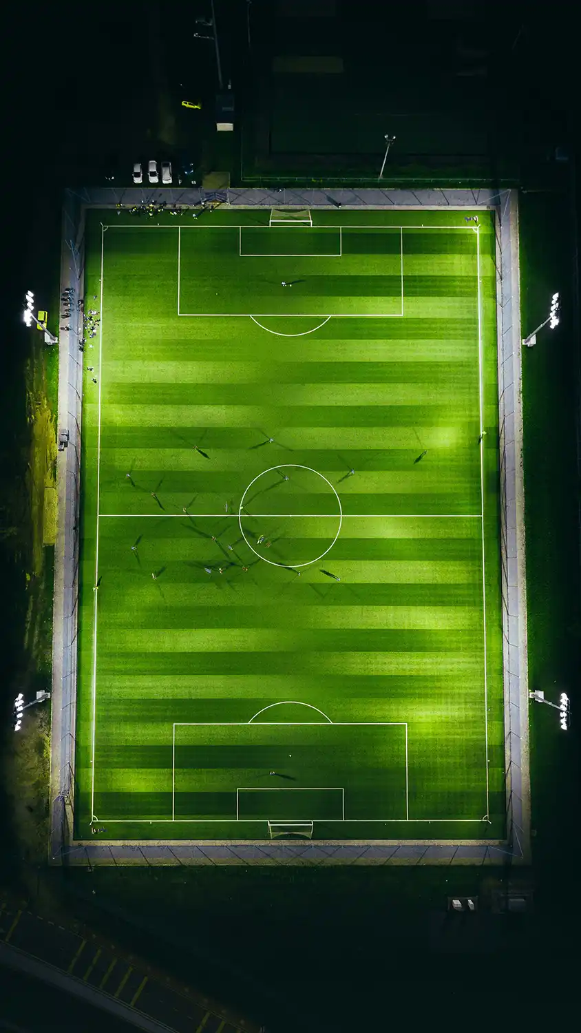 an overhead view of a football pitch at night