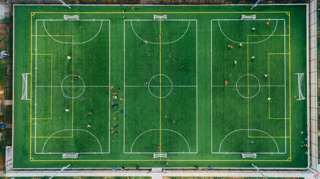 an overhead view of three football pitches side by side