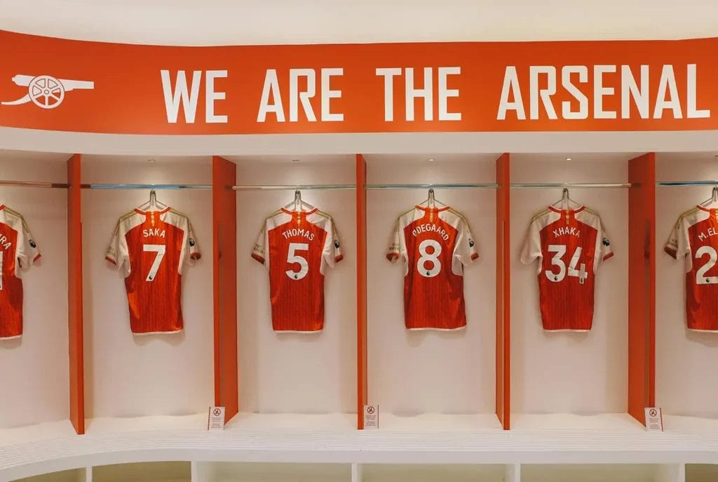 Football shirts hanging up in the dressing room of Arsenal Football Club
